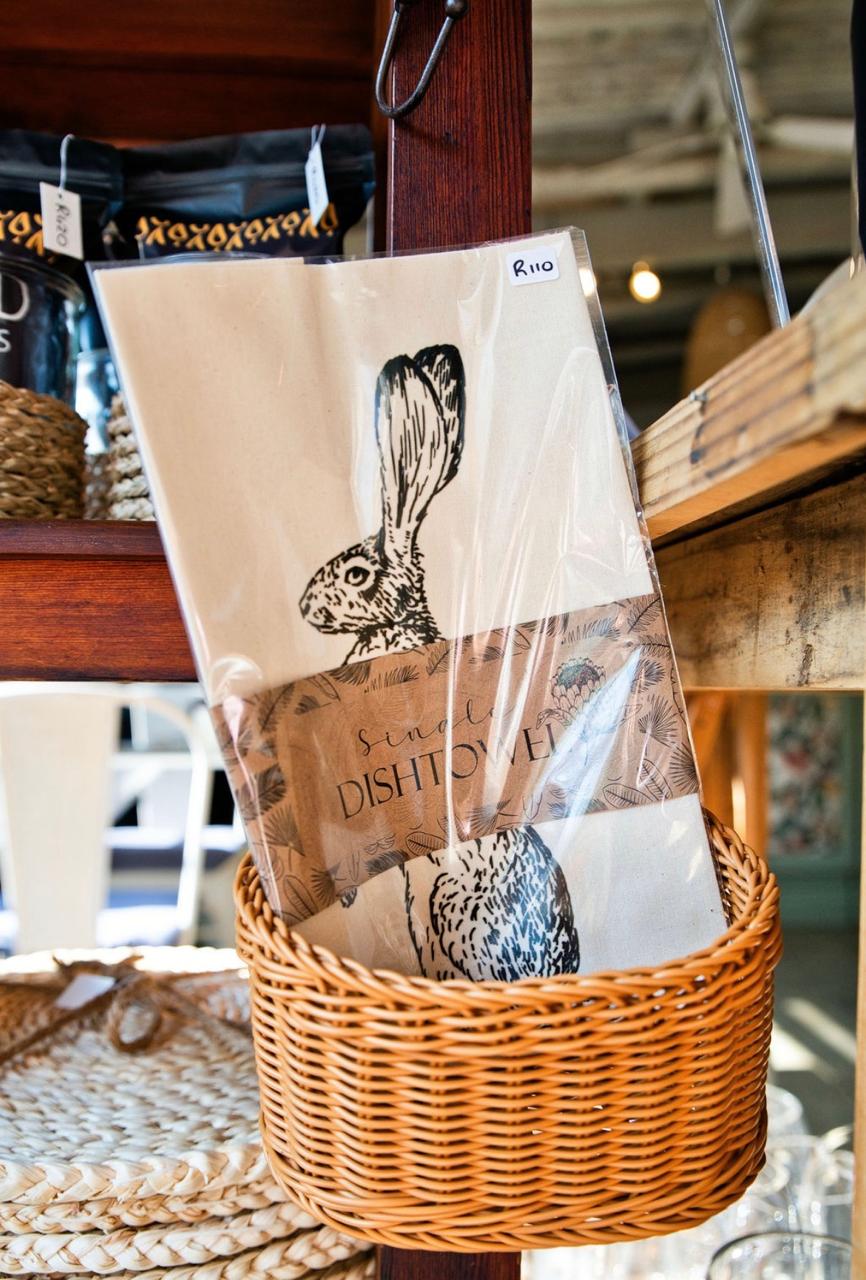 Single dishtowel with hare print, priced R110, hanging in a basket